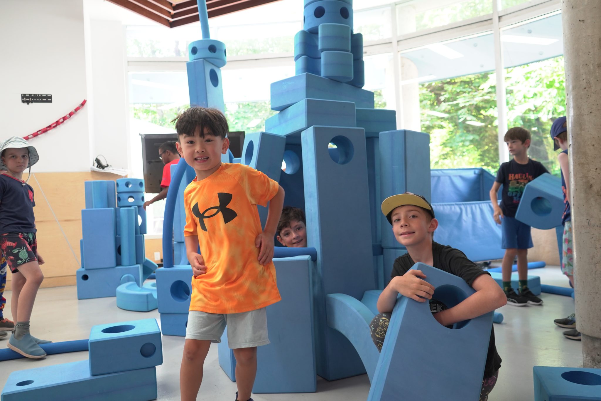 A group of kids playing with giant foam blocks